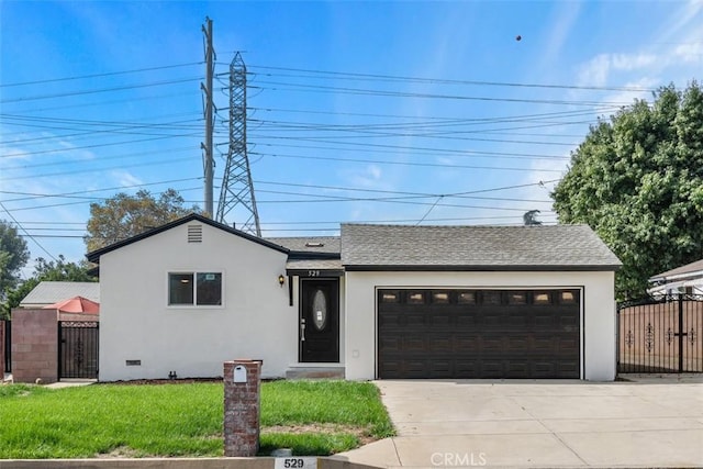 view of front of property with a front yard and a garage