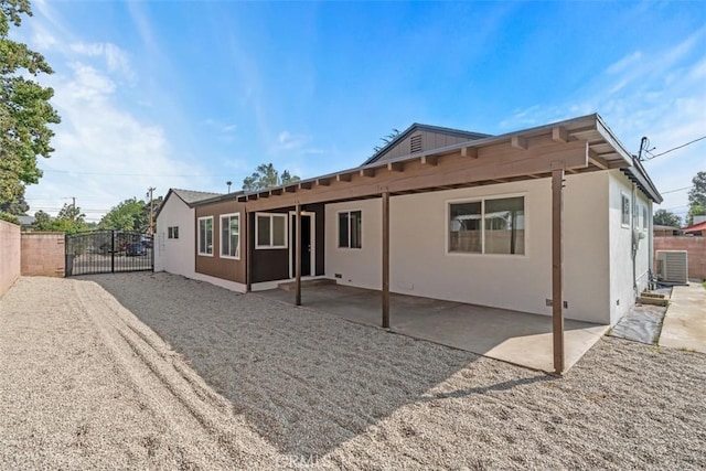 back of property featuring a patio area and central AC