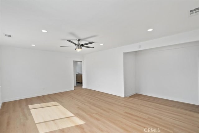 empty room featuring light wood-type flooring and ceiling fan