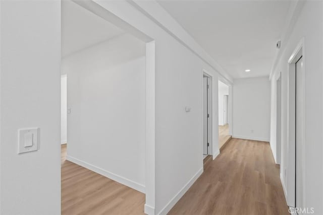 hallway with light hardwood / wood-style flooring