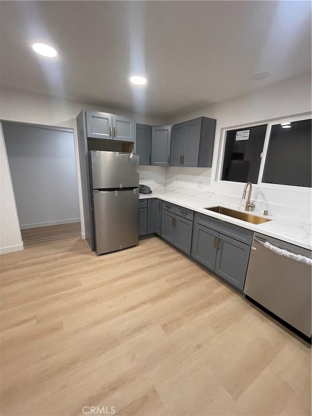 kitchen with sink, appliances with stainless steel finishes, and gray cabinetry