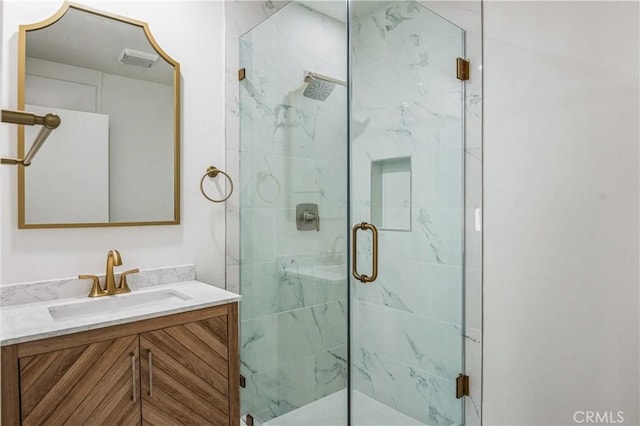 bathroom with walk in shower and vanity