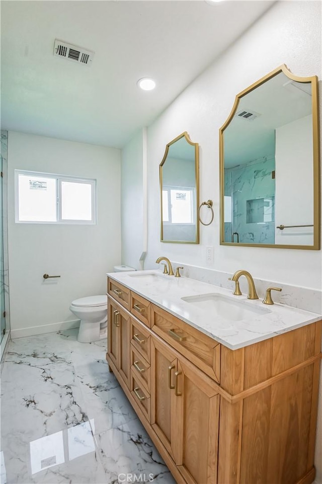 bathroom featuring vanity, toilet, and a shower with door