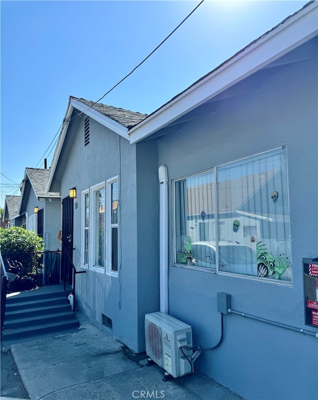 view of side of property with ac unit