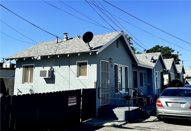 view of home's exterior with a wall mounted air conditioner