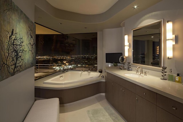 bathroom featuring tile patterned floors, vanity, and a bathing tub