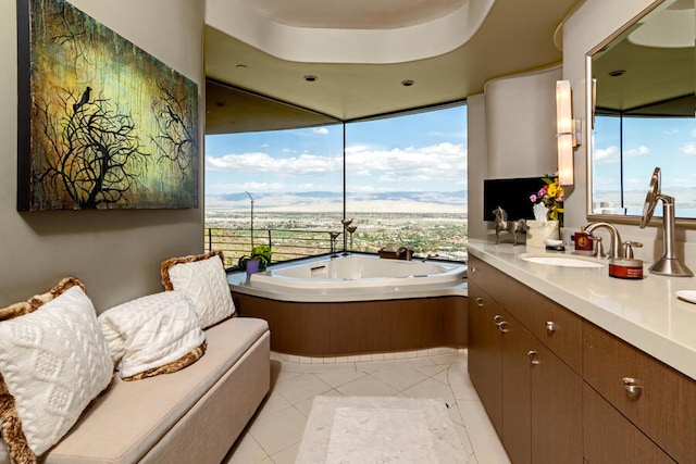 bathroom featuring vanity, a tub to relax in, and tile patterned flooring