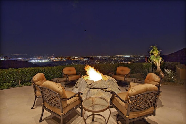 patio at twilight featuring an outdoor fire pit