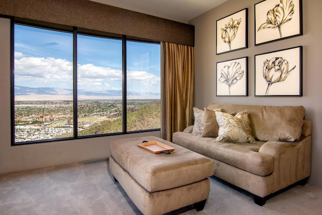 carpeted living room featuring a mountain view