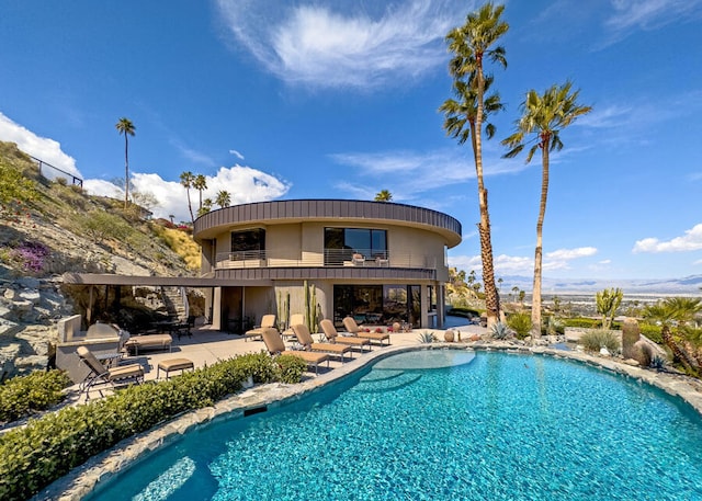 rear view of property with a balcony and a patio