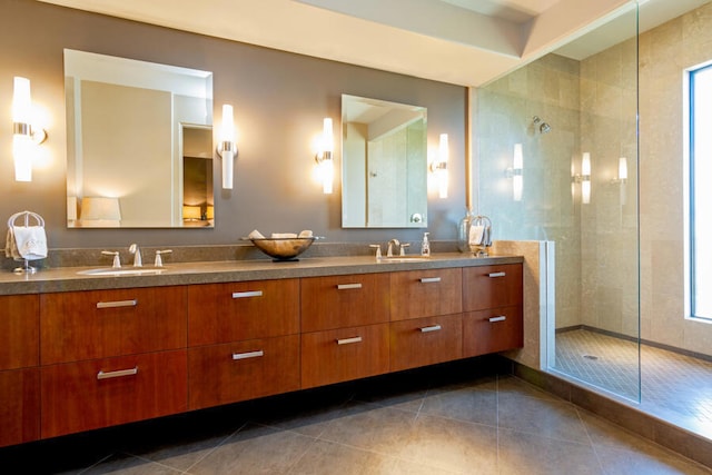 bathroom with tiled shower, tile patterned floors, and vanity