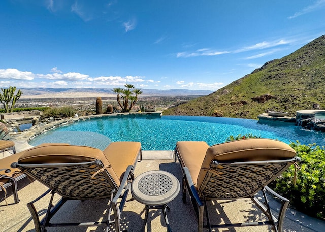 view of pool featuring a mountain view and pool water feature