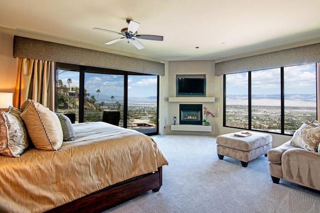 carpeted bedroom featuring access to exterior and ceiling fan