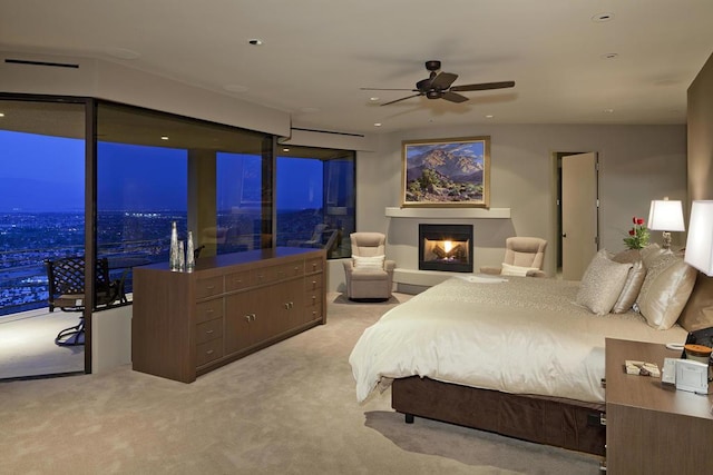 carpeted bedroom with ceiling fan and access to exterior