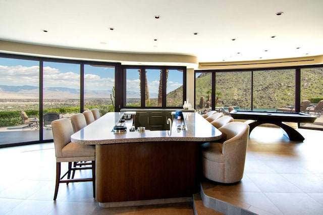 dining room featuring a mountain view and light tile patterned floors