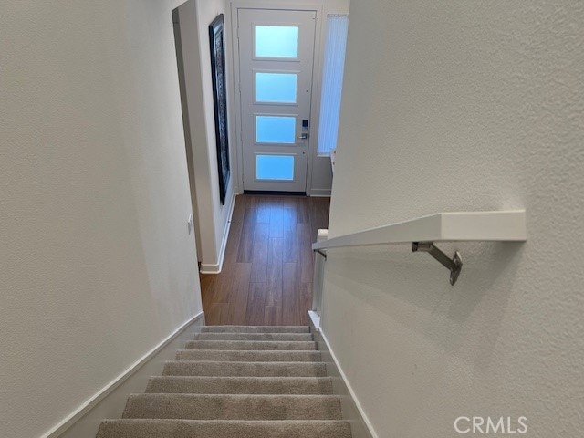 stairs with wood-type flooring