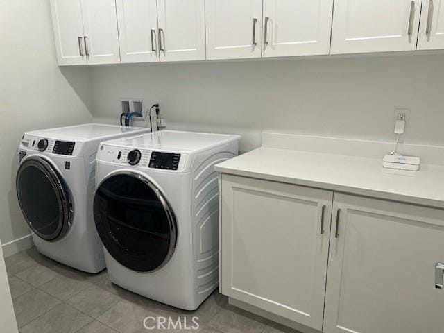 342 Sunrise Rd, Rancho Mission Viejo, CA 92694 - clothes washing area featuring washer and dryer, cabinet space, and light tile patterned flooring