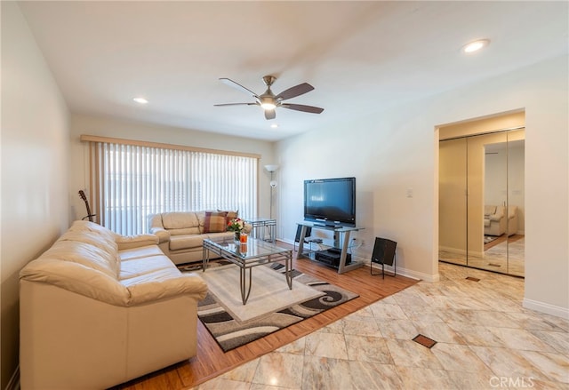 living room with light hardwood / wood-style floors and ceiling fan