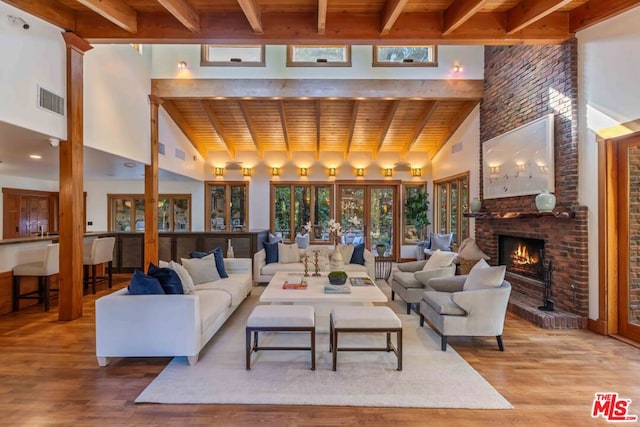 living room featuring beam ceiling, wood ceiling, and high vaulted ceiling