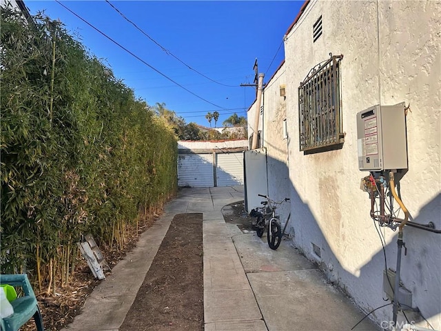 view of side of property featuring a garage and an outbuilding