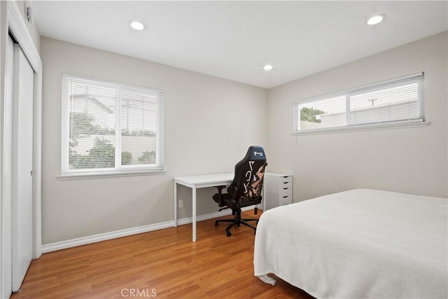 bedroom with wood-type flooring and a closet