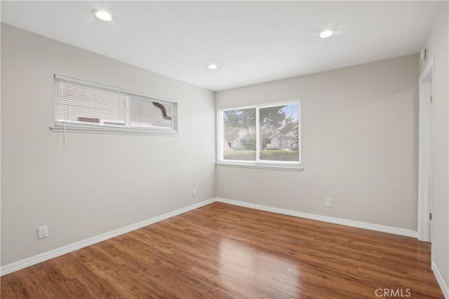 unfurnished room with hardwood / wood-style flooring