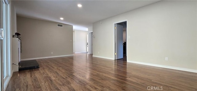 unfurnished living room featuring dark wood-type flooring