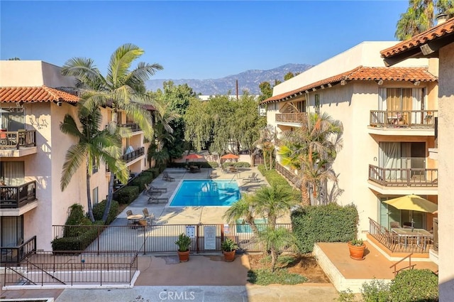 view of swimming pool with a patio area and a mountain view