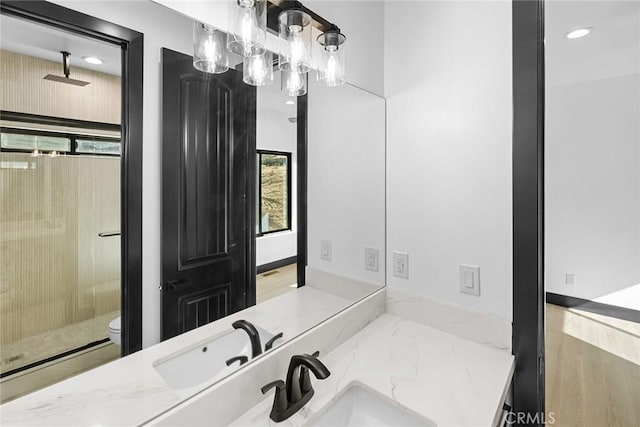 bathroom featuring walk in shower, vanity, toilet, and a wealth of natural light