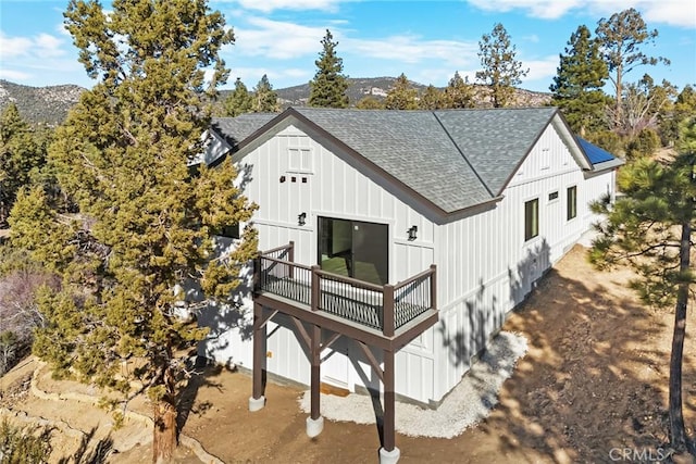 rear view of house with a deck with mountain view