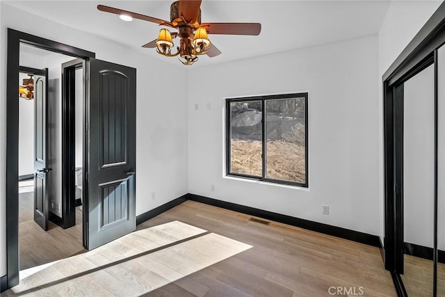 unfurnished bedroom with light hardwood / wood-style floors and ceiling fan