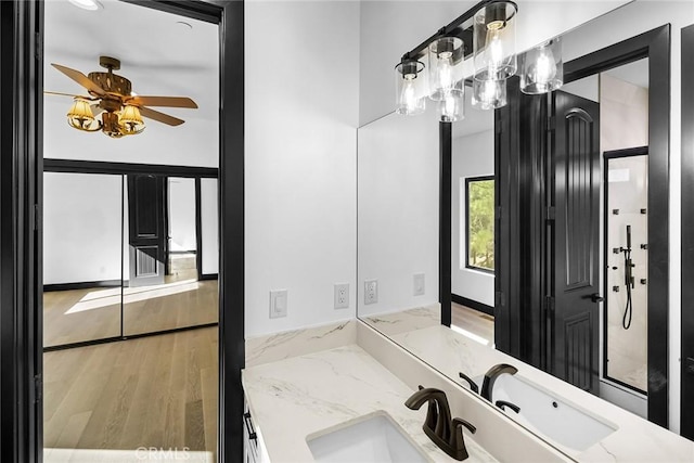 bathroom featuring wood-type flooring, vanity, and ceiling fan