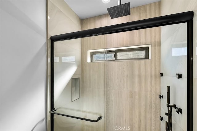 bathroom with a shower with shower door