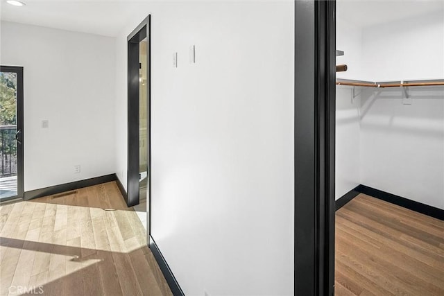 hallway with wood-type flooring