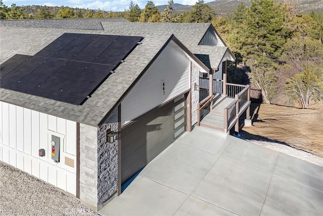 exterior space featuring solar panels and a garage