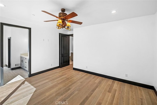 unfurnished bedroom with ceiling fan, light hardwood / wood-style floors, and ensuite bath