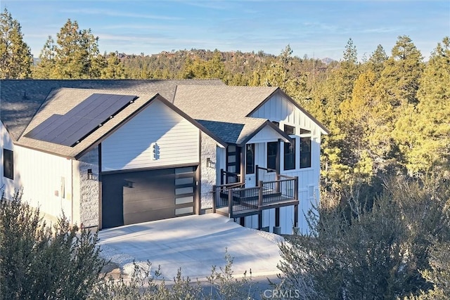 view of front of house featuring solar panels and a garage