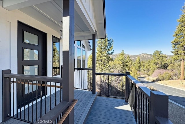 wooden deck featuring a mountain view