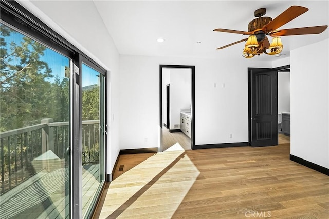 empty room featuring ceiling fan and light hardwood / wood-style flooring