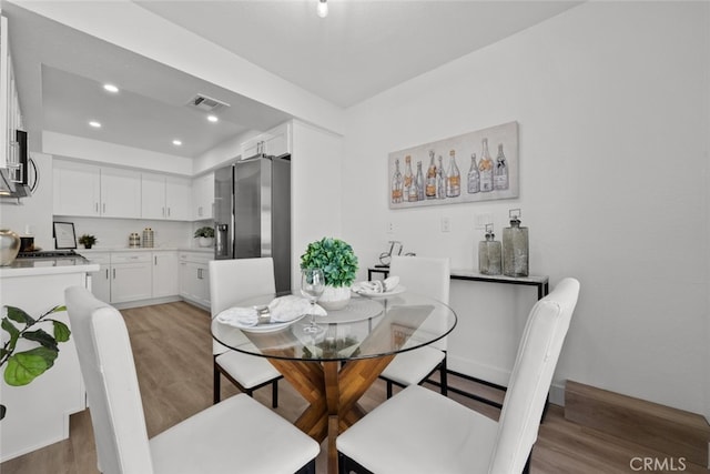 dining space with light hardwood / wood-style floors