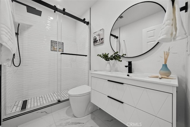 bathroom with vanity, toilet, and a shower with door