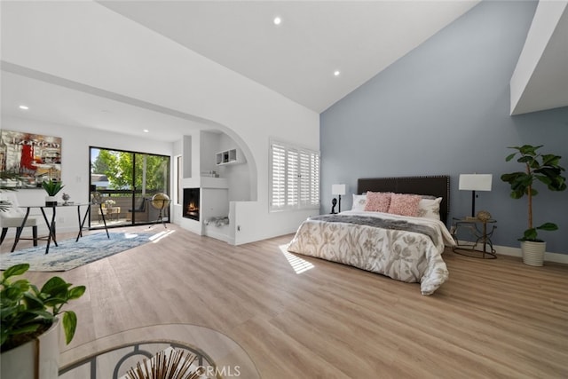 bedroom featuring vaulted ceiling and light wood-type flooring