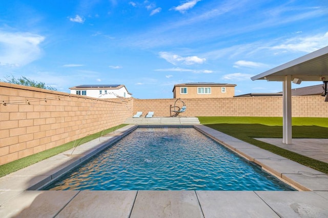 view of swimming pool with a yard