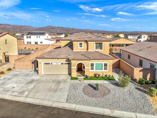 mediterranean / spanish-style home featuring a mountain view and a garage