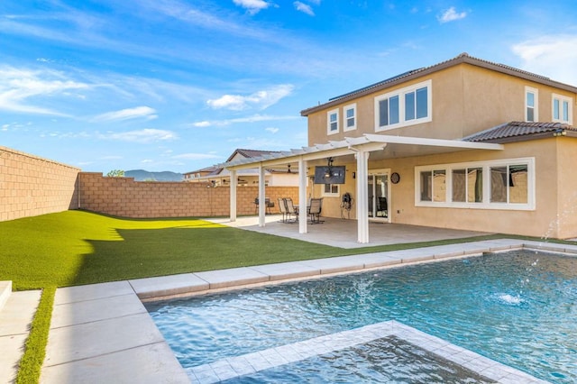 back of property with a lawn, a fenced in pool, a pergola, pool water feature, and a patio area