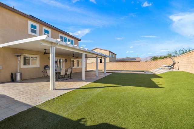 view of yard featuring ceiling fan and a patio area