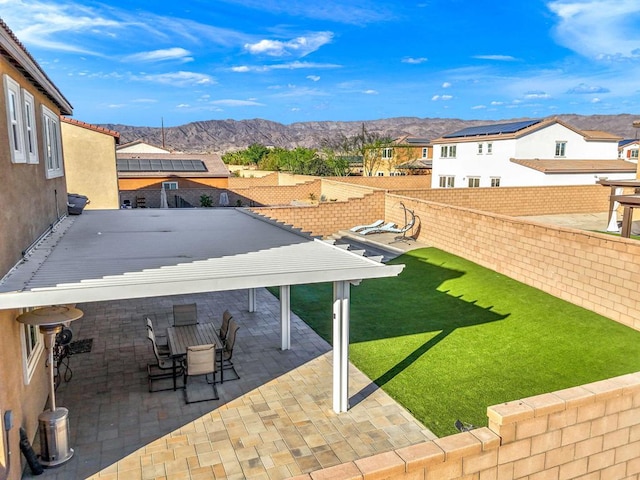 view of yard with a mountain view and a patio