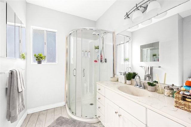 bathroom featuring vanity, walk in shower, and hardwood / wood-style flooring