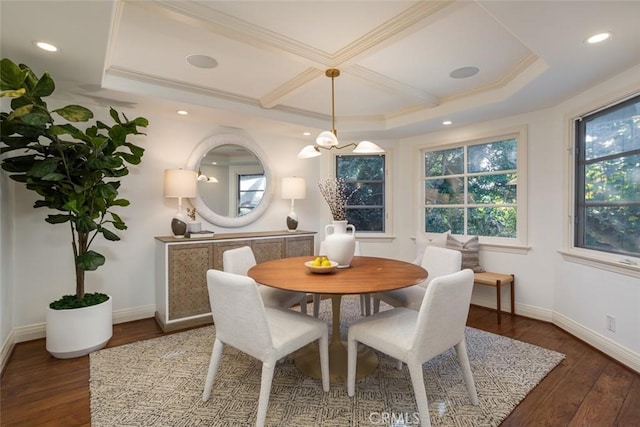 dining space with dark hardwood / wood-style flooring, crown molding, and an inviting chandelier