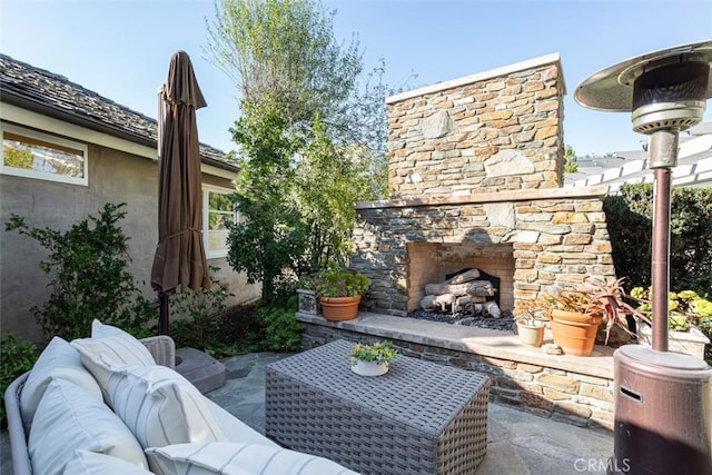 view of patio featuring an outdoor living space with a fireplace